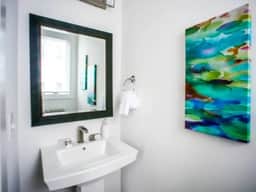 A half bath thoughtfully placed for easy access, ensuring comfort and functionality. Experience modern living with every detail considered!
