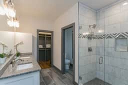 Connected to the Master bedroom (Bedroom 2) on the second floor, this elegant Master bathroom boasts a standing shower and his and her sinks, providing a luxurious and private retreat.