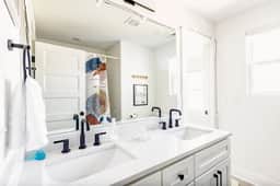 Equipped with his and hers sinks, this bathroom attached to bedroom 3 and bedroom 4 is a harmonious blend of style and functionality. Elevate your daily routine in this elegant and convenient space.