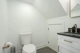 The half bathroom on the first floor offers easy access from the living, dining, and kitchen areas. A practical addition that ensures convenience for all your guests!
