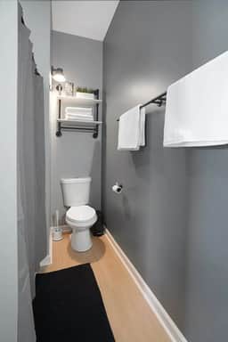 Experience pure comfort in this full bathroom, equipped with towels, shampoo, and soap.