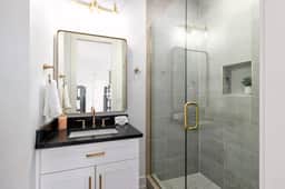 This full bathroom is connected to Bedroom 4. Experience a hotel-like comfort with elegant touches!
