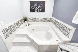 Deep-soak tub goals: pour the bubbles, pour the wine, and let the stress melt away.
