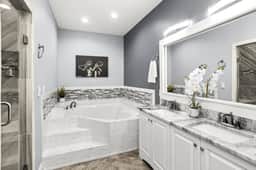 Pamper yourself in Bathroom 2, where luxury meets sophistication. A full bath with his and hers sinks, a lavish bathtub, and a touch of class. Your private spa retreat awaits!