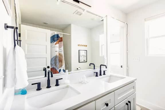 Equipped with his and hers sinks, this bathroom attached to bedroom 3 and bedroom 4 is a harmonious blend of style and functionality. Elevate your daily routine in this elegant and convenient space.