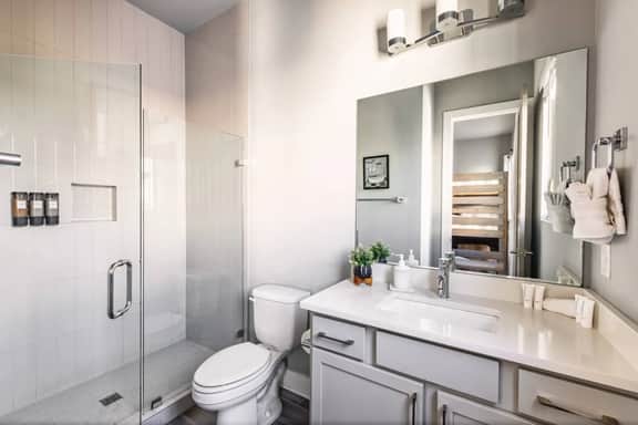 This full bathroom, attached to bedroom 4 on the fourth floor, offers a spacious shower. A perfect retreat after a day of exploring!