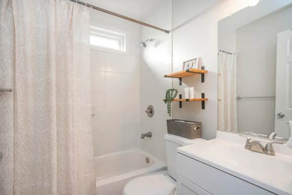 Unit B - Luxuriate in relaxation! Our bathroom presents a choice of shower or bath, immaculately clean and supplied with essential toiletries and soft towels for your utmost comfort!