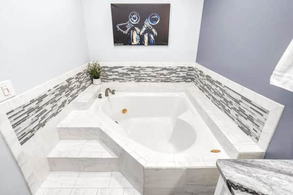 Deep-soak tub goals: pour the bubbles, pour the wine, and let the stress melt away.