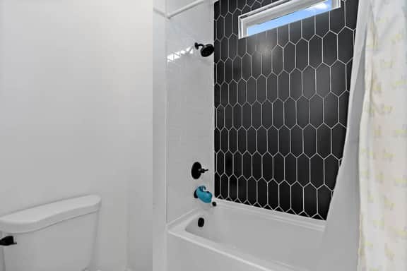 A spa-style escape with bold tile, a walk-in shower, and boutique touches that make every morning feel indulgent.