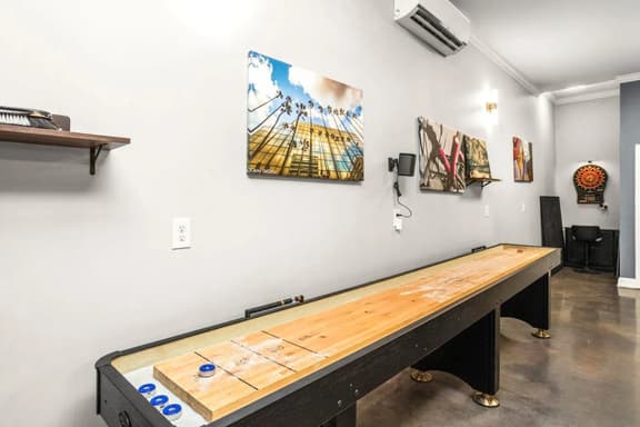 Slide, score, repeat. Shuffleboard nights are always better with good company and a drink in hand.